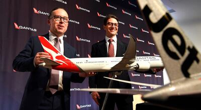 (FILES) A file photo taken on August 25, 2017, shows Qantas chief executive officer Alan Joyce (L) and chief financial officer Tino La Spina (R) posing for photos before a press conference for the company's full year results announcement in Sydney. - Australian flag carrier Qantas posted a 14.9 percent jump in annual net profit on August 23, 2018 with healthy returns across all sectors of its business. (Photo by William WEST / AFP)