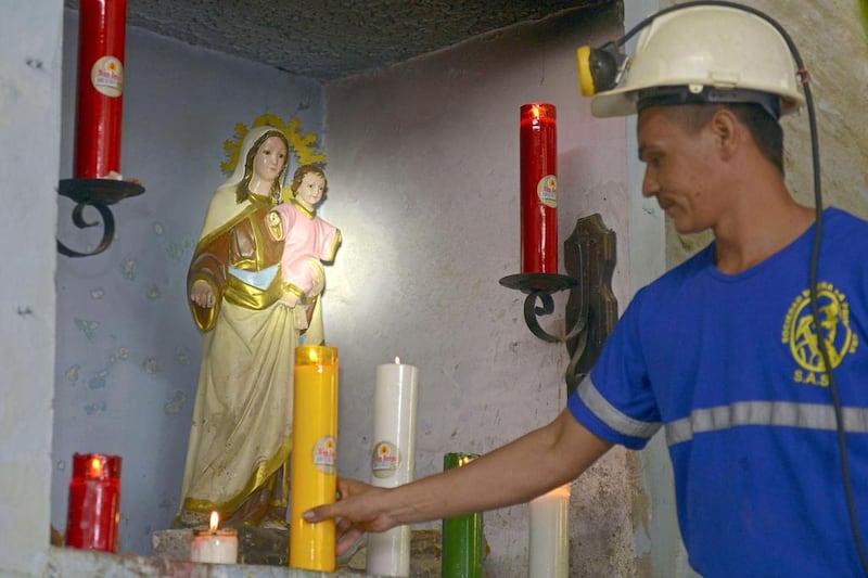 A miner lights a candle at 'La Primavera', a licensed gold mine in Segovia municipality. Raul Arboleda / AFP