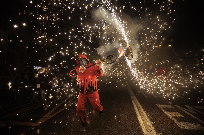 A 'demoni' takes part in the 'Cabalgata del Foc' ride during the 'Nit de la Crema' (Fire Night) in Valencia, eastern Spain, 19 March 2022.  The traditional Fallas feast is held in Valencia region annually until 19 March to commemorate Saint Joseph, the patron of carpenters.  The Fallas, installations of parodic huge papier-mache, cardboard, and wooden sculptures, are burnt on 19 March in the so-called 'Crema' to mark the end the Falles event.   EPA / BIEL ALINO