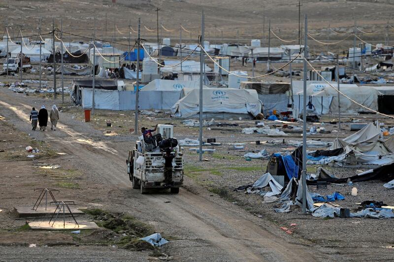 Displaced Iraqis load a lorry as they prepare to leave the Hammam Al Alil camp. Reuters