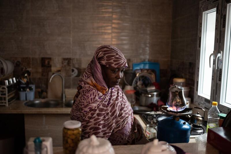 Mrs. Awaia, originally from Darfur Sudan, prepares a tea in the kitchen of her precarious accommodation in the area of Gargaresh, in the outskirts of Tripoli.