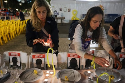 Women prepare a symbolic dinner table during a rally in Tel Aviv demanding the release of Israelis held hostage in the Gaza Strip. AFP