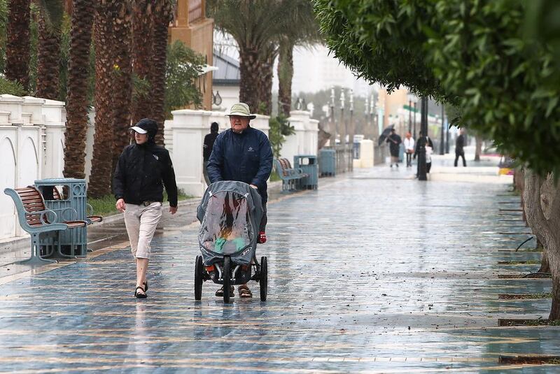 People walk during the rain in Abu Dhabi. Pawan Singh / The National