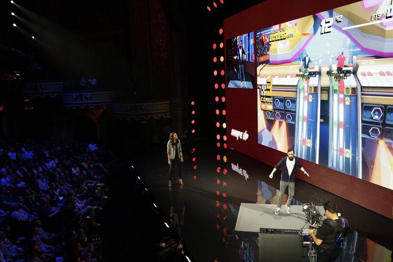 Creative director Charles Huteau at Ubisoft Montreal plays Shape Up as Aisha Tyler watches while introducing the game. Dan Krauss / Getty Images / AFP
