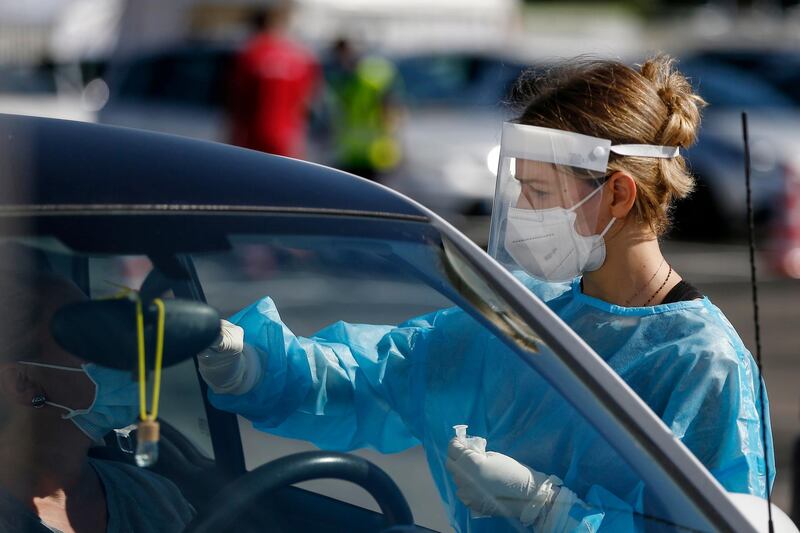 A medical staffer performs tests for Covid-19 at a drive-through at Rome's Leonardo Da Vinci airport. Italy’s new daily cases passed 5,372 on Friday, the highest levels since March.  AP
