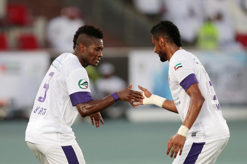 Asamoah Gyan, left, celebrates his goal in the 32nd minute with teammate Mohamed Ahmad in Al Ain's 1-0 President's Cup win over Al Ahli at Zayed Sports City in Abu Dhabi on May 18, 2014.  Christopher Pike / The National

