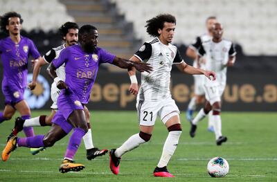 ABU DHABI, UNITED ARAB EMIRATES , March 14  – 2020 :-  Ahmed Barman (no 13 purple) of Al Ain and Omar Abdulrahman  (no 21 white) of Al Jazira in action during the Arabian Gulf League football match between Al Jazira v Al Ain held at Mohamed bin Zayed Stadium in Abu Dhabi. (Pawan Singh / The National) For Sports. Story by John