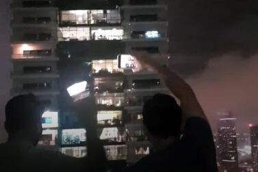 Dubai residents cheer and wave mobile phones from balconies as rain, thunderstorms hit the region. Courtesy of Parvathi Vidhun