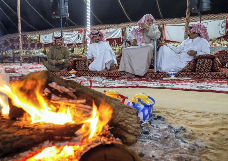 Abu Dhabi, United Arab Emirates, December 10, 2019.  
  --Men of the Dawasir tribe from Saudi Arabia relax after a victory at the Al Dhafra Festival in Abu Dhabi, UAE.
Victor Besa/The National
Section:  NA
Reporter:  Anna Zacharias