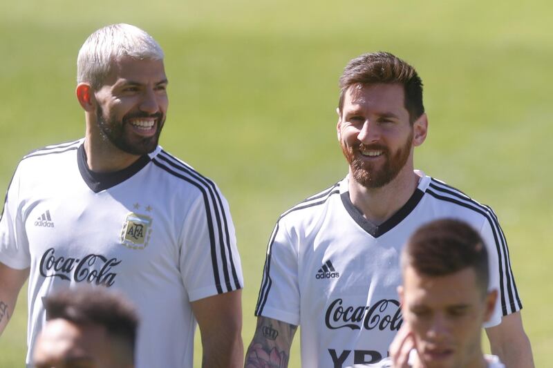Lionel Messi, right, and Argentina teammate Sergio Aguero share a joke during training. EPA