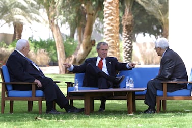 U.S. President George W. Bush discusses the Middle East peace process with Prime Minister Ariel Sharon of Israel (L) and Palestinian Prime Minister Mahmoud Abbas (R) in Aqaba, Jordan, June 4, 2003. REUTERS/Paul Morse/White House HK/ME