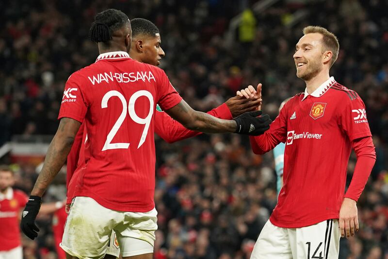 Manchester United's Christian Eriksen, right, celebrates scoring with teammates Marcus Rashford and Aaron Wan-Bissaka. AP