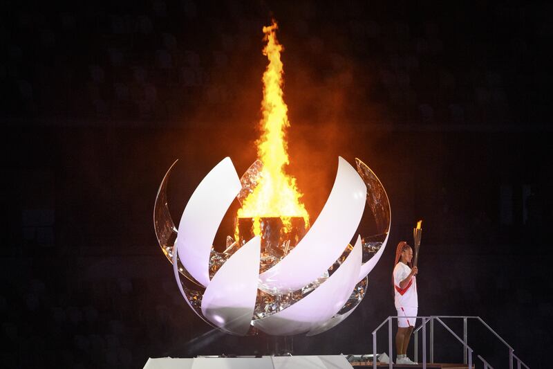 Naomi Osaka holds the Olympic torch after lighting the Olympic Cauldron during the opening ceremony of the 2020 Tokyo Summer Olympics at the National Stadium in Tokyo, Japan, 23 July 2021. EPA-EFE