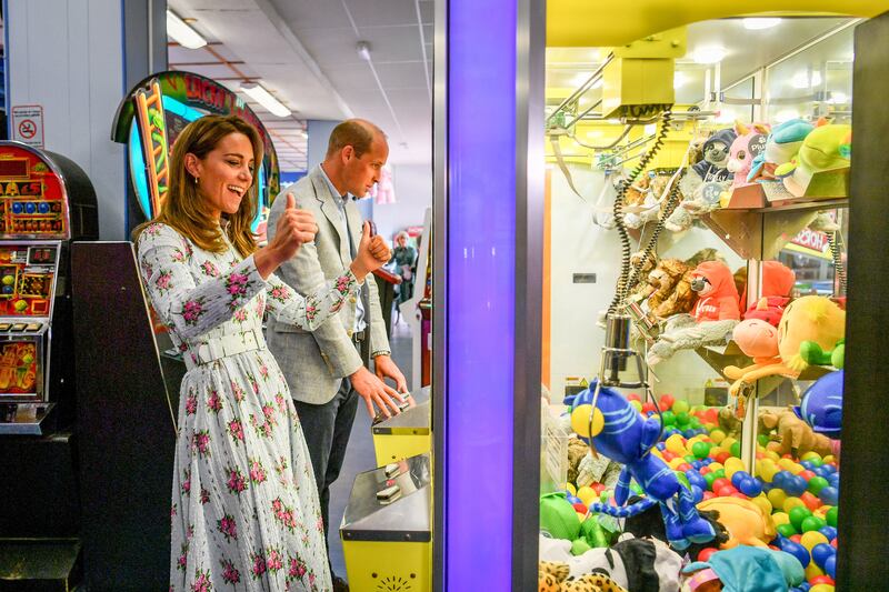 The royal couple play a grab-a-teddy game during a visit to Barry Island, South Wales, to speak to local business owners about the effect of Covid-19 on the tourism sector in August 2020