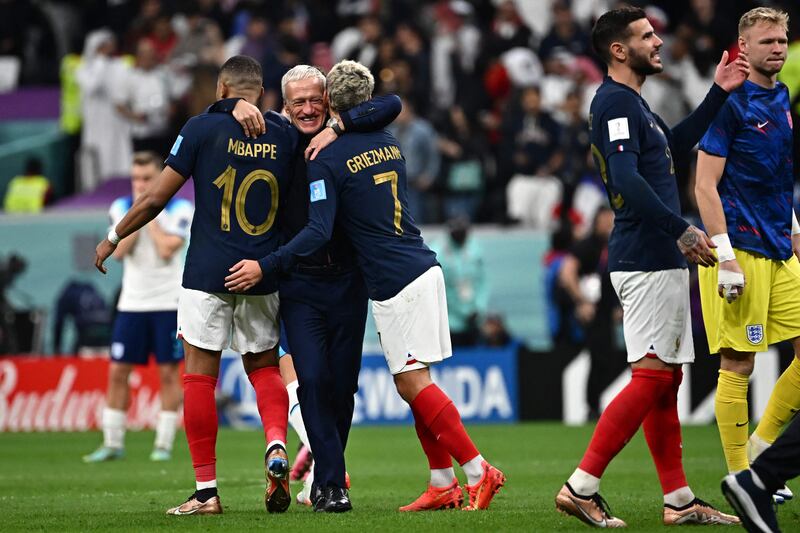 France's coach Didier Deschamps celebrates with Mbappe, left and Griezmann. AFP