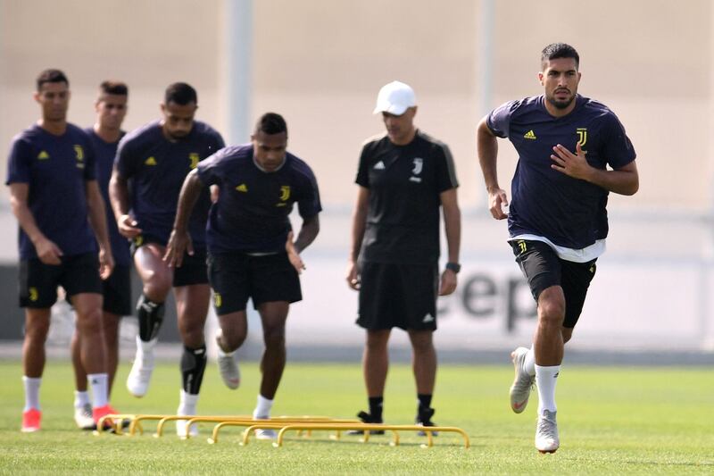 Juventus' German midfielder Emre Can (R) takes part in a training session on September 18, 2018 in Turin, on the eve of the Champions League group stage football match Valence vs Juventus. / AFP / Marco BERTORELLO
