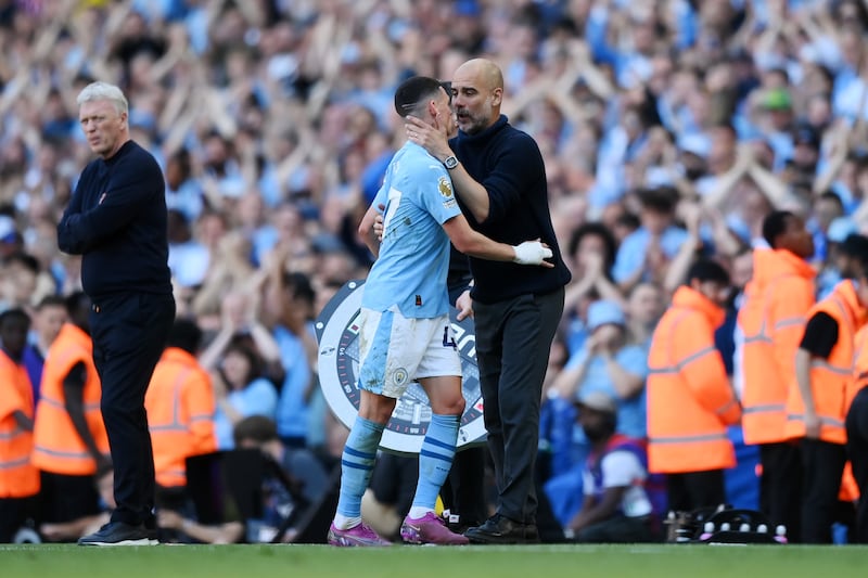 Phil Foden is embraced by Manchester City manager Pep Guardiola as he leaves the pitch whilst being substituted. Getty Images