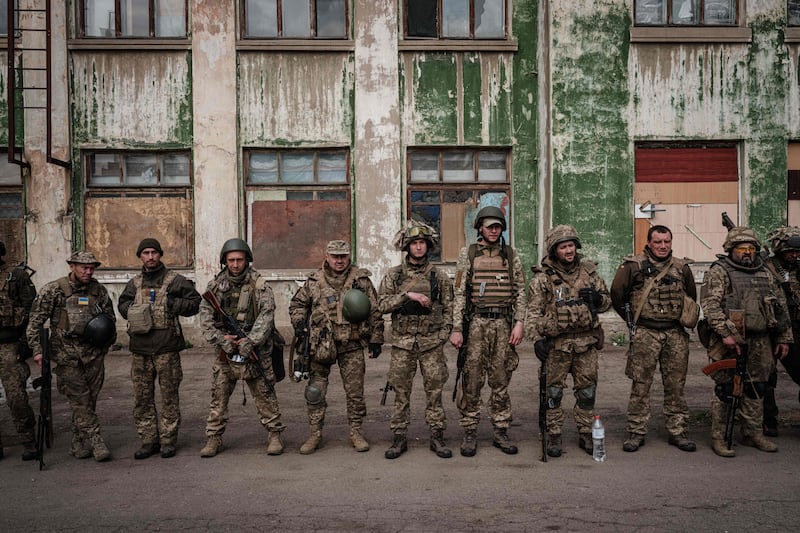 Exhausted Ukrainian soldiers arrive at an abandoned building to rest and for medical treatment after fighting on the front line near Kramatorsk. AFP