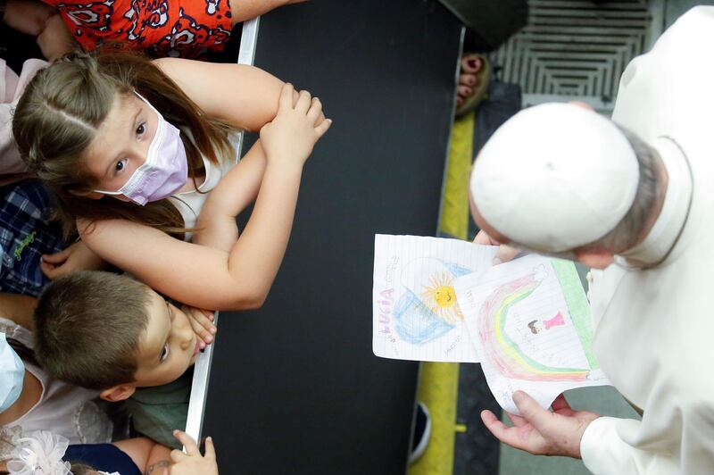 Pope Francis receives drawings from children at the Paul VI Audience Hall, at the Vatican. Reuters