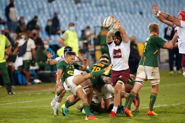 South Africa's scrum-half Herschel Jantjies (L) kicks the ball while Georgia's flanker Beka Saginadze (3rd R) chases him down during the first rugby union Test match between South Africa and Georgia at Loftus Versfeld stadium in Pretoria on July 2, 2021.  (Photo by PHILL MAGAKOE  /  AFP)