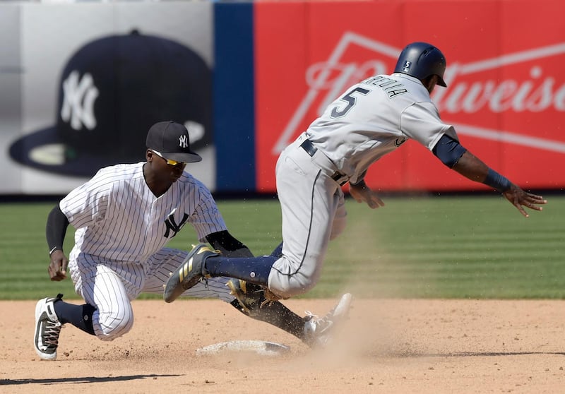 Seattle Mariners pinch runner Guillermo Heredia is tagged out by New York Yankees shortstop Didi Gregorius during the eighth inning of a baseball. Bill Kostroun / AP Photo