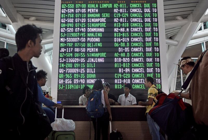 Passengers ask staff about their flights near the flight screen after Ngurah Rai airport closed their operation due to eruption of Mount Agung in Bali. Antara Foto / Fikri Yusuf / via Reuters