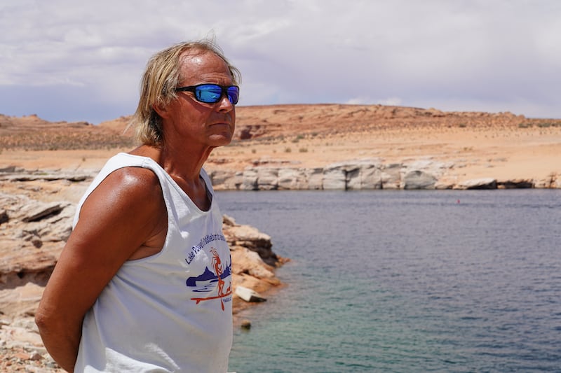 Joe Lapekas, owner of Lake Powell Paddleboards in Page, Arizona, looks out at the water.