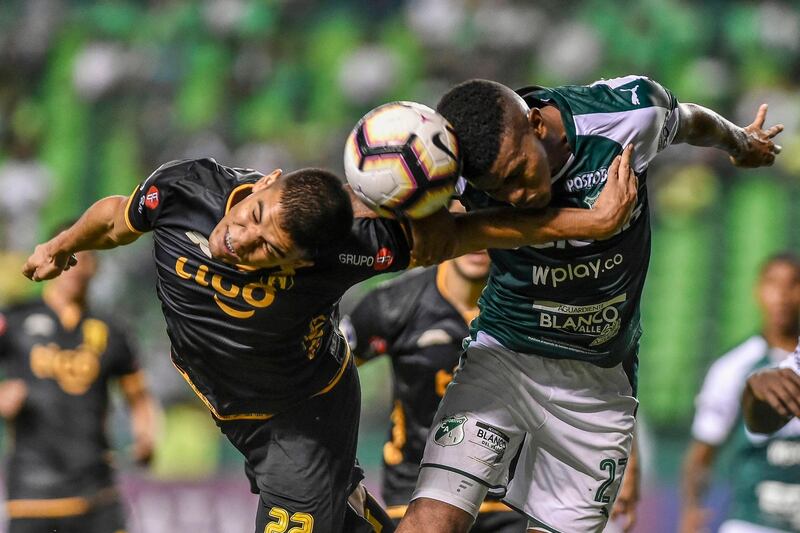 Guarani's Rodney Redes, left, vies for the ball with Deportivo Cali's Darwin Andrade during their Copa Sudamericana match in Palmira, Colombia. AFP