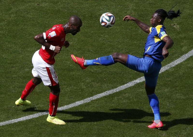 Switzerland's Johan Djourou fights for the ball with Ecuador's Felipe Caicedo during their 2014 World Cup Group E match on Sunday. David Gray / Reuters