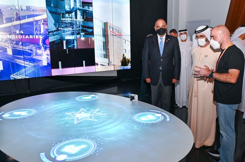 Sheikh Mohammed views an exhibit at the Jordan pavilion, accompanied by Jordanian Prime Minister Bisher Al Khasawneh.