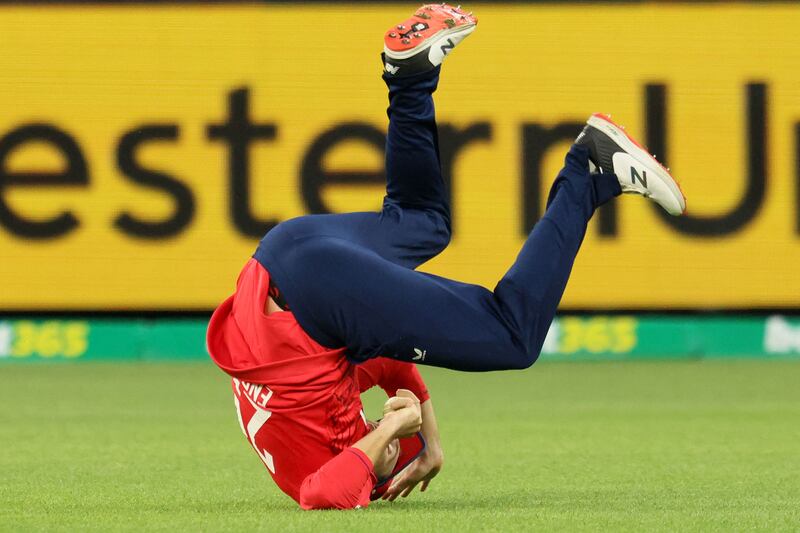 England's Dawid Malan tumbles after his successful catch to dismiss Australia's Marcus Stoinis. AFP