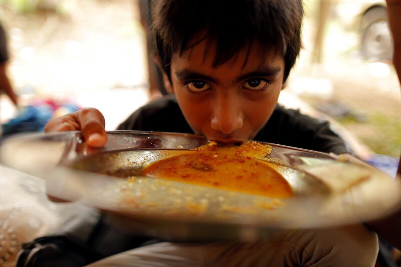 A refugee boy eats at the Ahmadiyya Muslim Community Centre in Pasyala, Sri Lanka. Reuters