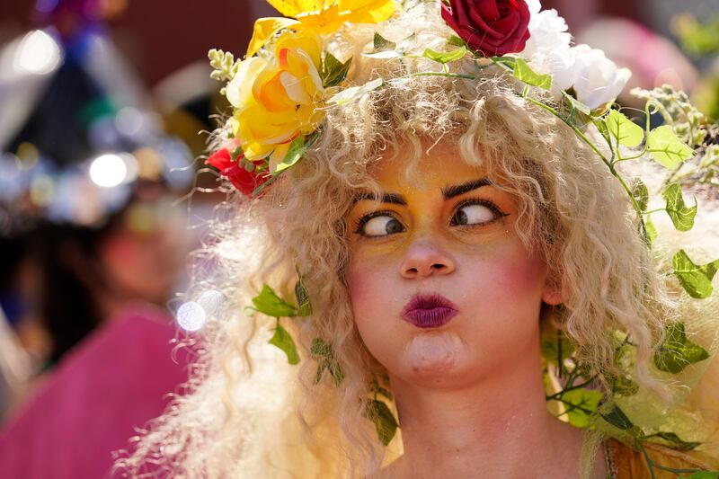 A person makes faces during the Societe de Sainte Anne parade. AP