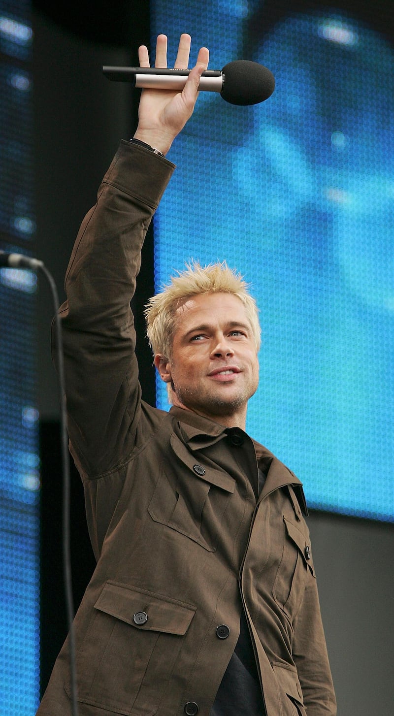 LONDON - JULY 02:  Actor Brad Pitt on stage at "Live 8 London" in Hyde Park on July 2, 2005 in London, England.  The free concert is one of ten simultaneous international gigs including Philadelphia, Berlin, Rome, Paris, Barrie, Tokyo, Cornwall, Moscow and Johannesburg.  The concerts precede the G8 summit (July 6-8) to raising awareness for MAKEpovertyHISTORY.  (Photo by MJ Kim/Getty Images)