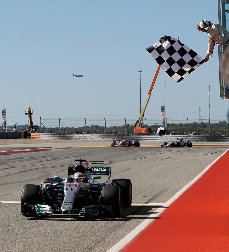 Mercedes driver Lewis Hamilton crosses the finish line to clinch the win and move a step closer to winning the world title. Tony Gutierrez / AP Photo