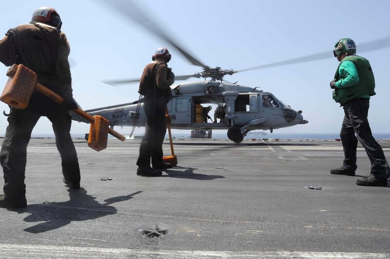 An MH-60S Sea Hawk helicopter from the "Nightdippers" of Helicopter Sea Combat Squadron (HSC) 5 lands on the flight deck of the Nimitz-class aircraft carrier USS Abraham Lincoln (CVN 72) during a replenishment-at-sea operation. US Navy