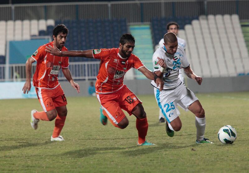 Abu Dhabi, United Arab Emirates - November 24, 2012.  ( Right to Left ) Mohamed Zidan Abdalla ( n0 25 of Bani Yas ),  Ahmed Al Yassi ( no 18 of Ajman ) and Ali Khamis Mohamed ( no 15 of Ajman ) battles for ball possession, at the Etisalat Pro League football match.  ( Jeffrey E Biteng / The National )