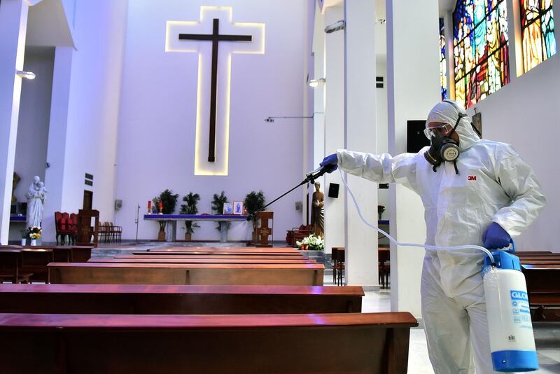 Sanitary workers disinfect a church in Beirut. AFP