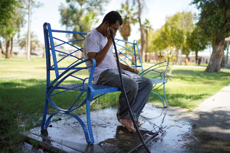 Daniel, a homeless man, cools off in a park during the heatwave in Mexicali, Mexico. Reuters 