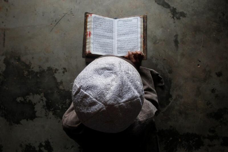 A Muslim boy learns to read the Koran at a madrassa, or religious school, during the holy month of Ramadan. Javanta Dey / Reuters