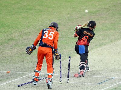 Dubai, United Arab Emirates - November 02, 2019: Netherland's Roelof van der Merwe bowls PNG's Lega Siaka during the game between Papua New Guinea and the Netherlands in the T20 World Cup Qualifier final at the Dubai International Cricket Stadium. Saturday the 2nd of November 2019. Sports City, Dubai. Chris Whiteoak / The National