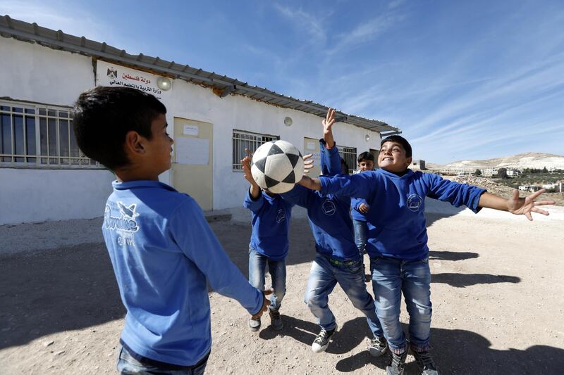 Children play in a school playground in the West Bank village of Jeb Deeb, near Bethlehem. EPA