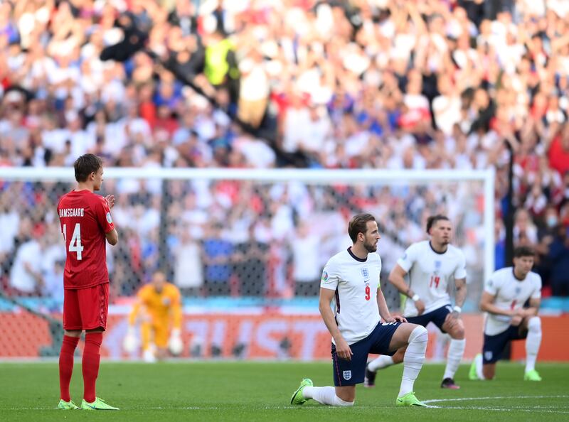 England player Harry Kane, centre, and teammates take a knee to support anti racism prior to the Euro 2020 semi final between England and Denmark. EPA