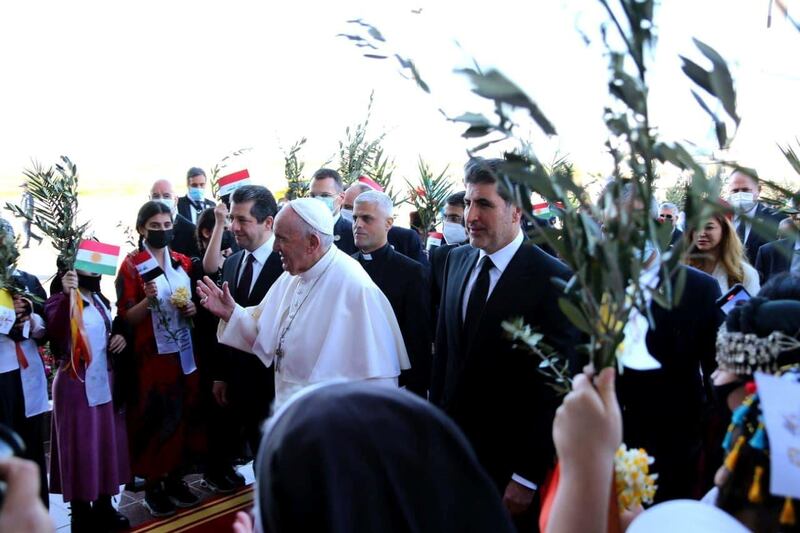 Pope Francis walks with Masrour Barzani, Prime Minister of Kurdistan region, and President of the Kurdistan region in Iraq Nechirvan Barzani, upon his arrival at Erbil International Airport. Reuters