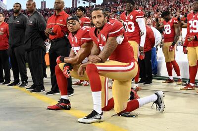 (FILES) In this file photo taken on September 11, 2016  Colin Kaepernick #7 and Eric Reid #35 of the San Francisco 49ers kneel in protest during the national anthem prior to playing the Los Angeles Rams in their NFL game at Levi's Stadium in Santa Clara, California. Former NFL star Colin Kaepernick, who launched kneeling protests during US national anthems to protest police brutality and racial injustice, will be the subject of a six-part series, Netflix announced June 29, 2020. - 
 / AFP / GETTY IMAGES NORTH AMERICA / Thearon W. Henderson
