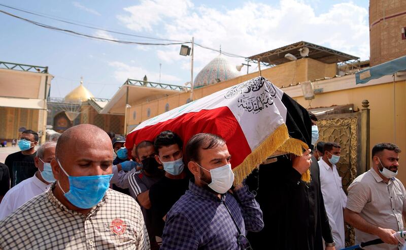 Mourners pray carry the coffin of slain Iraqi jihadism expert Hisham al-Hashemi, who was shot dead yesterday outside his house in the Iraqi capital, before his burial on July 7, 2020 in the Shiite shrine city of Najaf in central Iraq.
              The killing of the 47-year-old prominent expert has stirred fears Iraq is entering a dark and violent phase, as boiling tensions between pro-Iran factions and the government reach new heights.  / AFP / -
