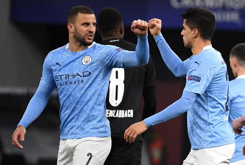 Kyle Walker, left, and Joao Cancelo of Manchester City celebrates after a goal against Borussia Monchengladbach during the Champions League last-16 second-leg match in Budapest on March 16. EPA