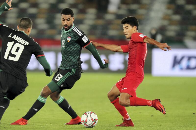 ABU DHABI , UNITED ARAB EMIRATES , January 21 ��� 2019 :- Khamis Esmaeel Zayed ( no 13 in green UAE ) and Sagynbaev Bekzhan ( no 11 in red of Kyrgyz Republic ) in action during the AFC Asian Cup UAE 2019 football match between UNITED ARAB EMIRATES vs. KYRGYZ REPUBLIC held at Zayed Sports City in Abu Dhabi. ( Pawan Singh / The National ) For News/Sports