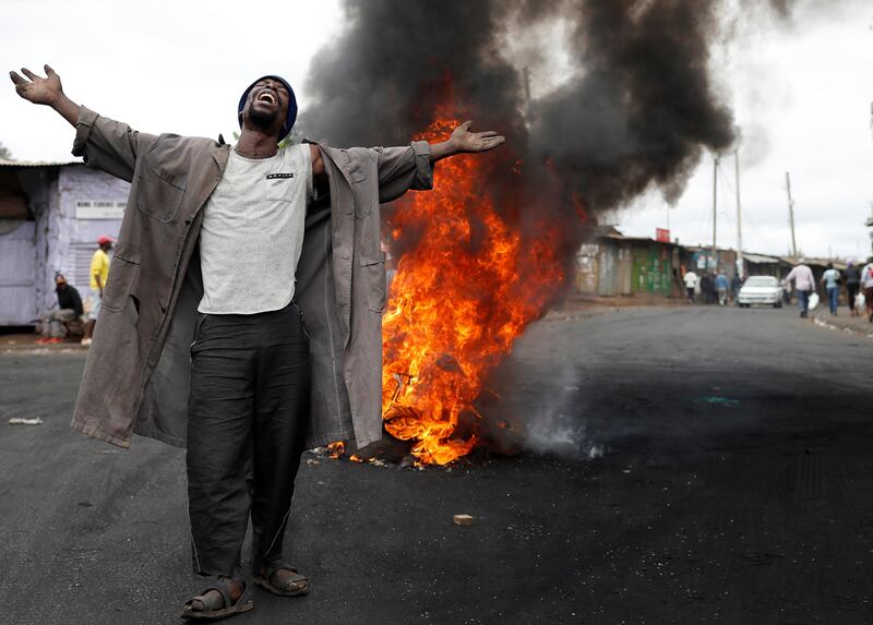 A supporter of Kenyan opposition leader Raila Odinga gestures in front of a burned barricade in a slum in Nairobi. Goran Tomasevic / Reuters