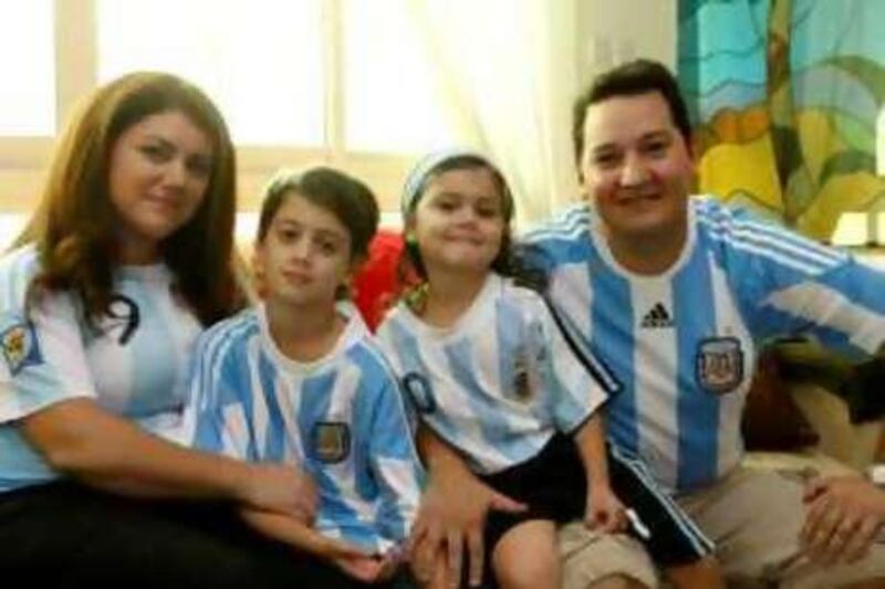 Ras Al Khaimah,  29th May 2010.  (Left to right) Clarisa Carubin (mother), Faustino Villanueva (9 years old), Felicitas Villanueva (4 years old) and Emiliano Villanueva (father), are avid supporters of their Argentinian Football national team.  Held at their residence.  (Jeffrey E Biteng / The National)